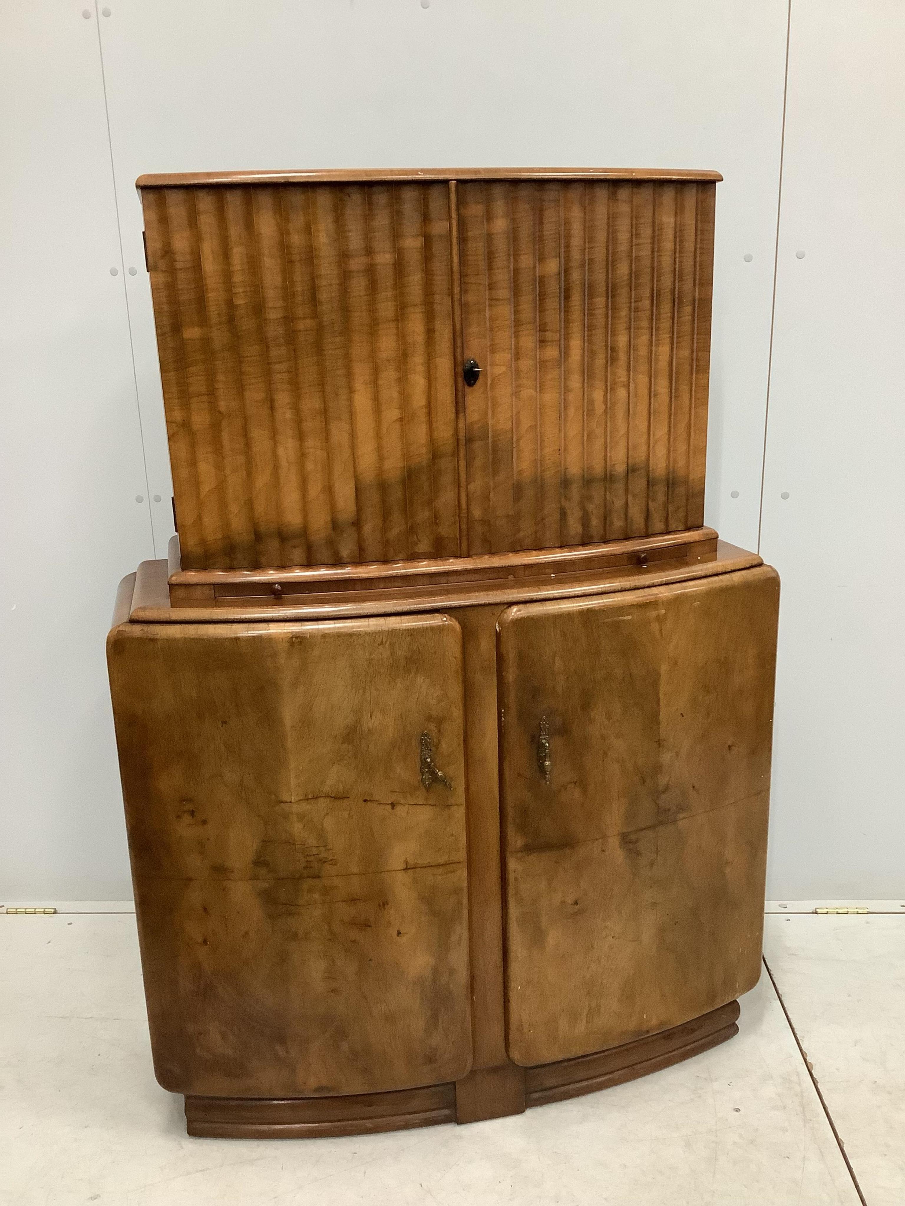 An Art Deco style walnut cocktail cabinet, width 102cm, depth 38cm, height 144cm. Condition - fair